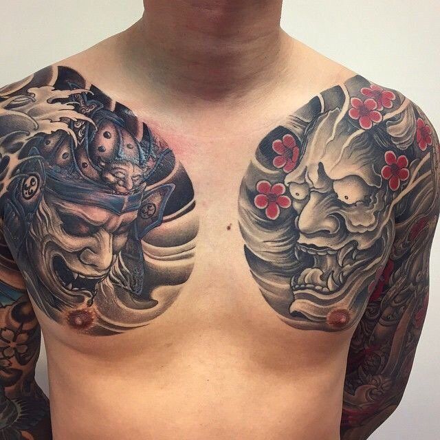 a man with tattoos on his chest and shoulder