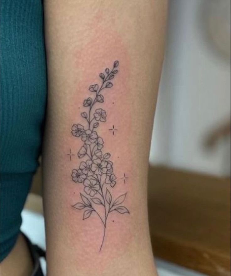 a small flower tattoo on the arm