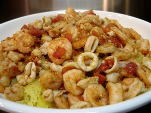 a white bowl filled with pasta and shrimp