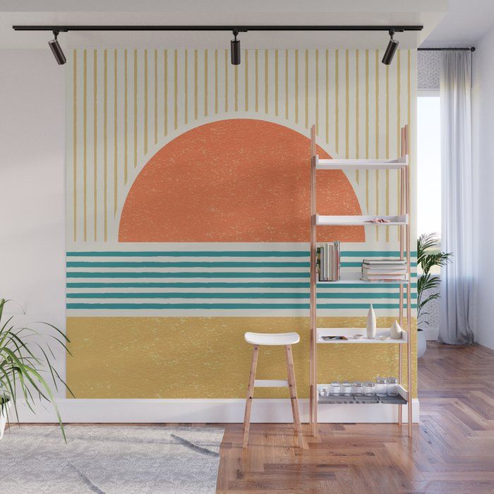 an orange and blue wall mural in a living room with a ladder to the right