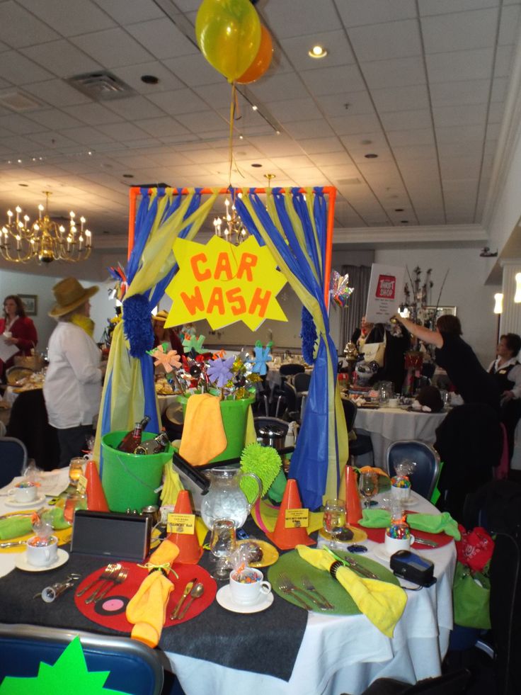 a table set up for a party with balloons and decorations