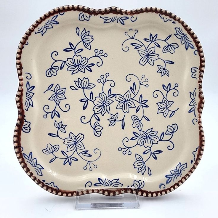 a decorative blue and white plate on a stand