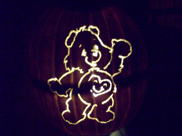 a carved pumpkin with a teddy bear on it