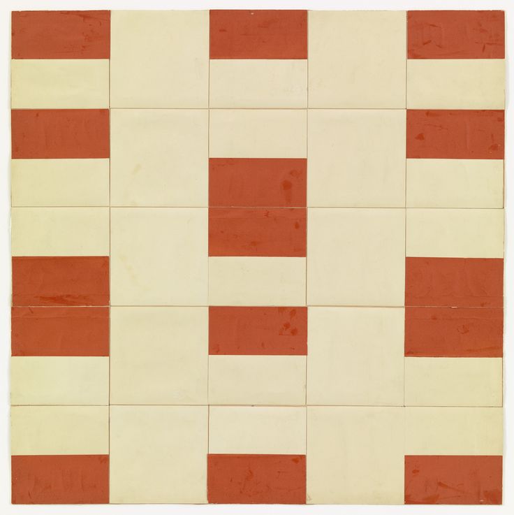 an orange and white tiled wall with red squares on it's sides, in the center