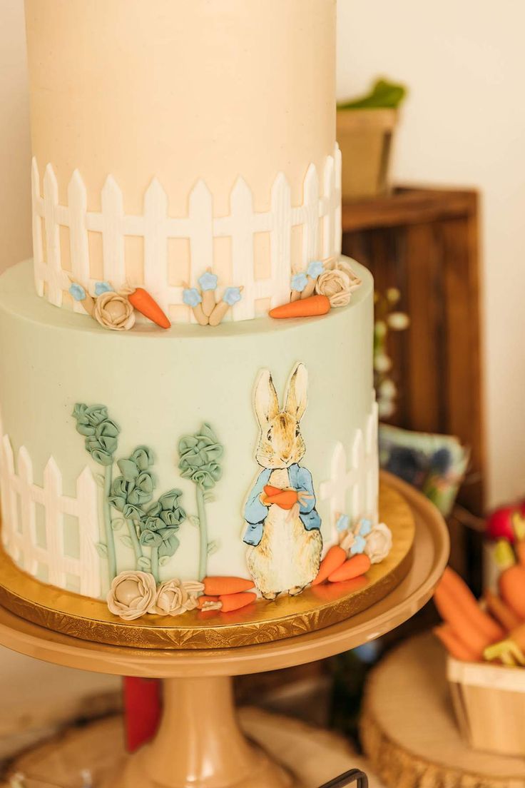 a three tiered cake decorated with an image of a rabbit on it's side