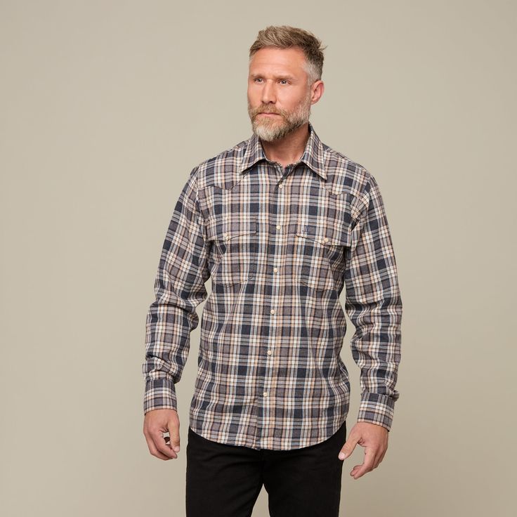 The Denver Flannel will have you feeling warm and stylish when separating cows or out walking on a cool night. This Western flannel is a 70% cotton 30% modal blend, featuring a cowboy yoke in front and back with a subtle, embroidered mirrored-L emblem on the left pocket and lower placket. Classic cowboy fit. Model is 6'1 and wearing size M. Country Style Button-up Shirt For Fall, Western Fall Flannel Shirt With Button Closure, Western Style Flannel Shirt For Fall, Western Style Flannel Shirt With Button Closure For Fall, Western Style Relaxed Fit Shirt For Fall, Western Brown Cotton Shirt, Rugged Long Sleeve Cotton Flannel Shirt, Western Style Brown Cotton Shirt, Casual Cotton Flannel Shirt For Rodeo