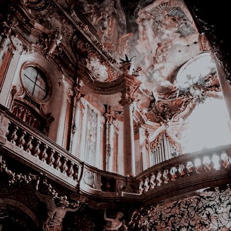 an ornate building with many clocks on the side of it's walls and balconies