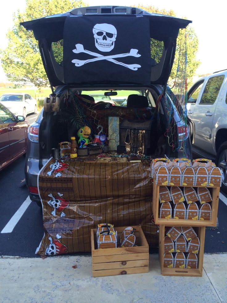 the trunk of a car is loaded with pirate decorations and other things to be sold