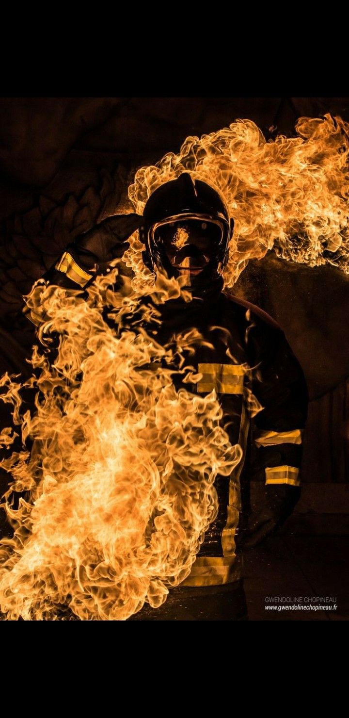 a firefighter with flames in his hands