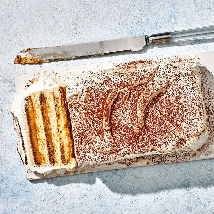 a cake on a plate with a knife next to it