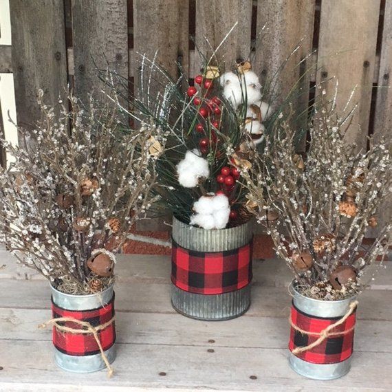 three tin cans with christmas decorations in them