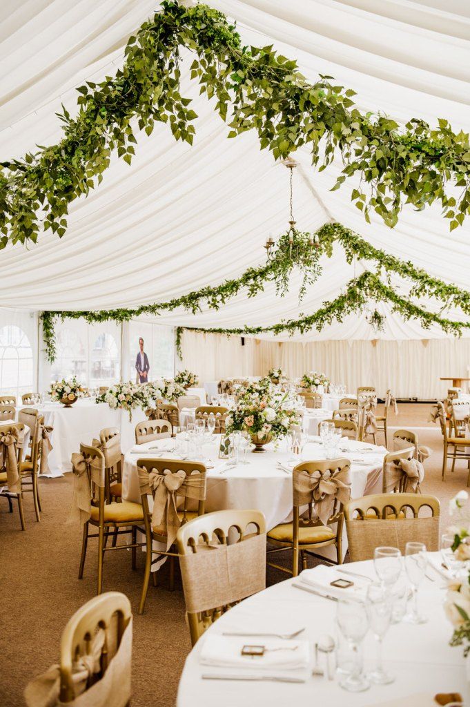 the inside of a large tent with tables and chairs set up for an event or function