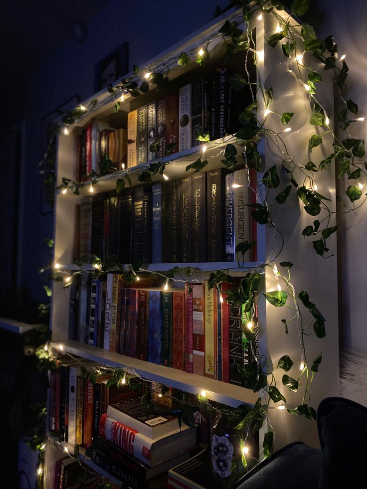 a bookshelf filled with lots of books covered in lights