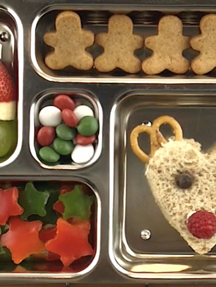 a metal tray filled with lots of food and pretzels in the shape of reindeers