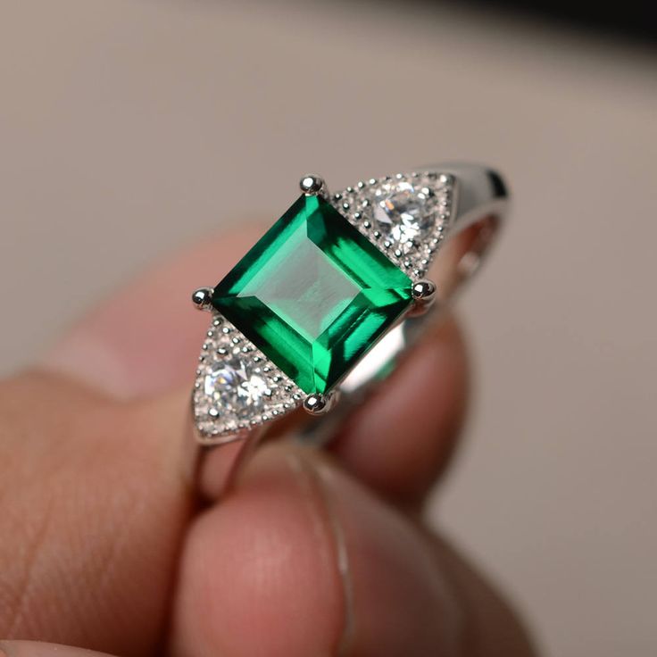 This is a gorgeous handmade creation. Its beauty is its simplicity & Elegance. The 7*7 mm square shape faceted lab emerald is crafted in solid sterling silver and with rhodium plated. All item is sent in a beautiful gift box If you have any idea of design your ring,pls contact me directly. You can realize more lovely stuff clicking the link https://www.etsy.com/shop/knightjewelry?refshopsection_shophome_leftnav Please leave the correct address and you phone number for delivering successfully Elegant Emerald Birthstone Ring Princess Cut, Elegant Emerald Princess Cut Birthstone Ring, Elegant Asscher Cut Emerald Ring In Sterling Silver, Silver Emerald Ring With Asscher Cut Cubic Zirconia, Princess Cut Emerald Ring With Diamond Details, Wedding Emerald Ring With Square Cut, Rectangular Solitaire Emerald Jewelry, Emerald Rings With Accent Stones Princess Cut, Silver Emerald Ring With Diamond Cut For May Birthstone