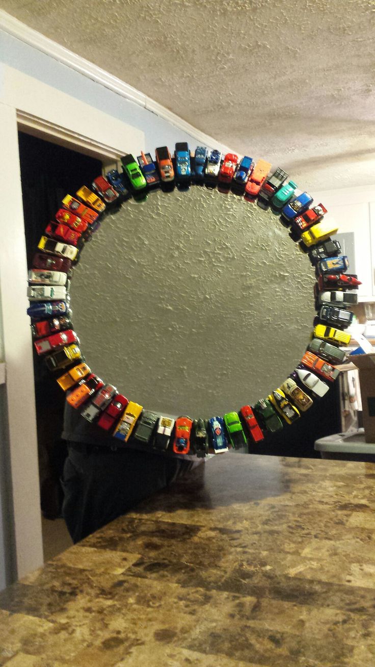 a mirror made out of toy cars sitting on top of a counter