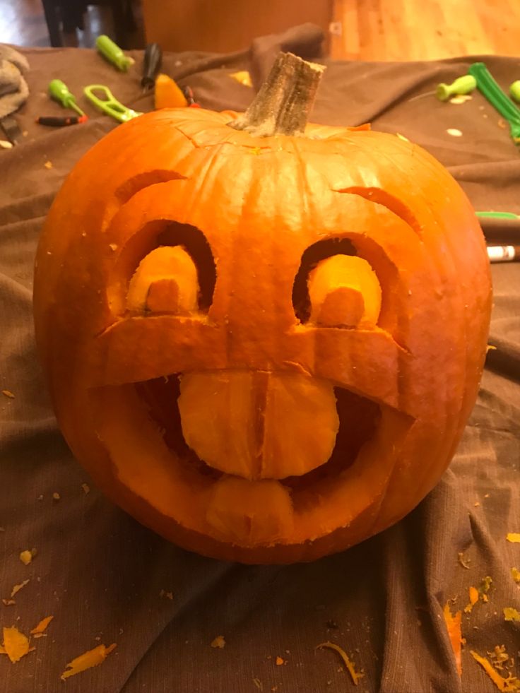 a carved pumpkin with an evil face on it