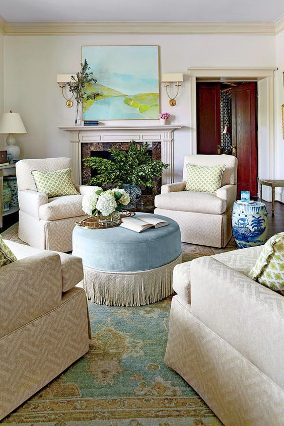 a living room filled with furniture and a fire place under a painting on the wall