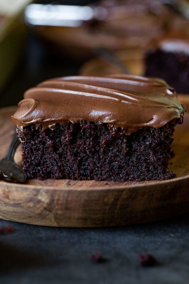 a piece of chocolate cake on a wooden plate