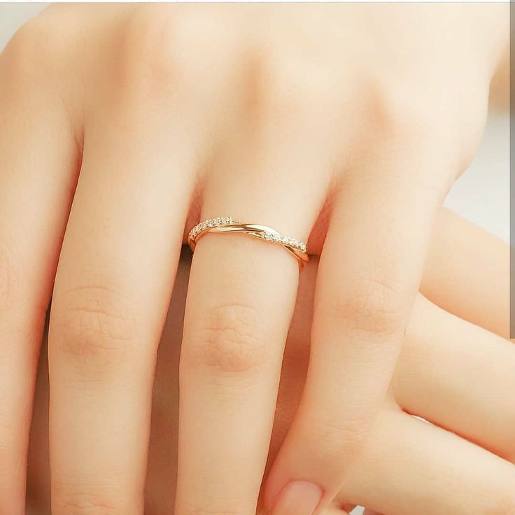 a woman's hand with a gold ring on it