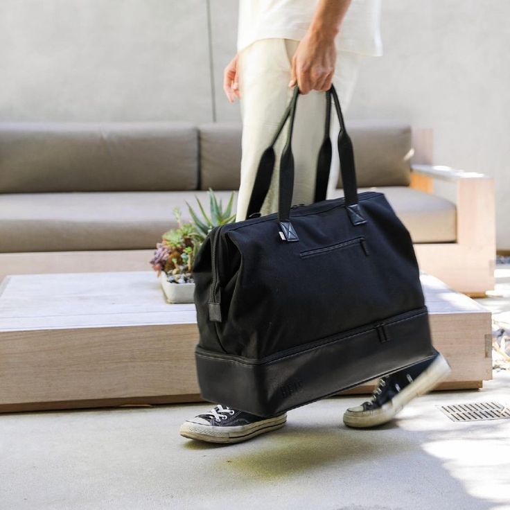 We searched the internet to find the best Weekender bag dupes that have a similar design — complete with trolley sleeves, shoulder straps, top handles, and easy-access compartments — at affordable prices. Check out our top picks. Beis Weekender Bag, Black Travel Bag, Weekend Duffle Bag, Travel Tote Bag, Overnight Bags, Black Travel, Duffle Bags, Weekender Tote, Sporty Outfits