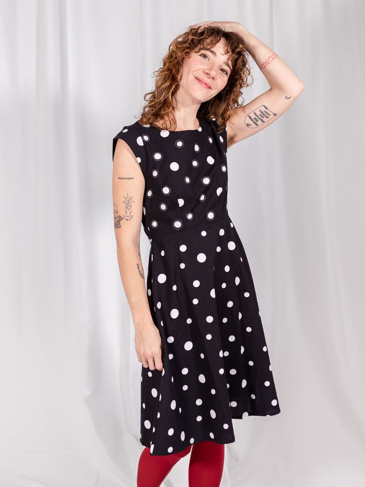 Go mod in this bold fit and flare dress. Its punchy polka dots, accented with contrasting hand embroidery, make a playful print that could be paired with bright tennis shoes for a fun everyday look or some tights and heels to fancy it up a bit. Fit Note: True to size. Fitted style. Those in between sizes may wish to size up. 100% cotton Hand screen printed. Hand embroidery Zips at back. Length of size M is 40.5" from top of bodice Made fair trade in India by one of our longstanding production pa French Knot Embroidery, Tights And Heels, Fair Trade Clothing, Screen Printed Fabric, Red Maxi, Red Dress Maxi, Fitted Style, Polka Dress, Oversized Style