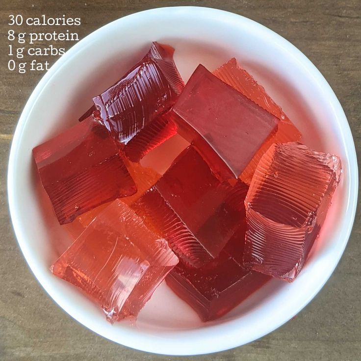 a white bowl filled with red gummy bears