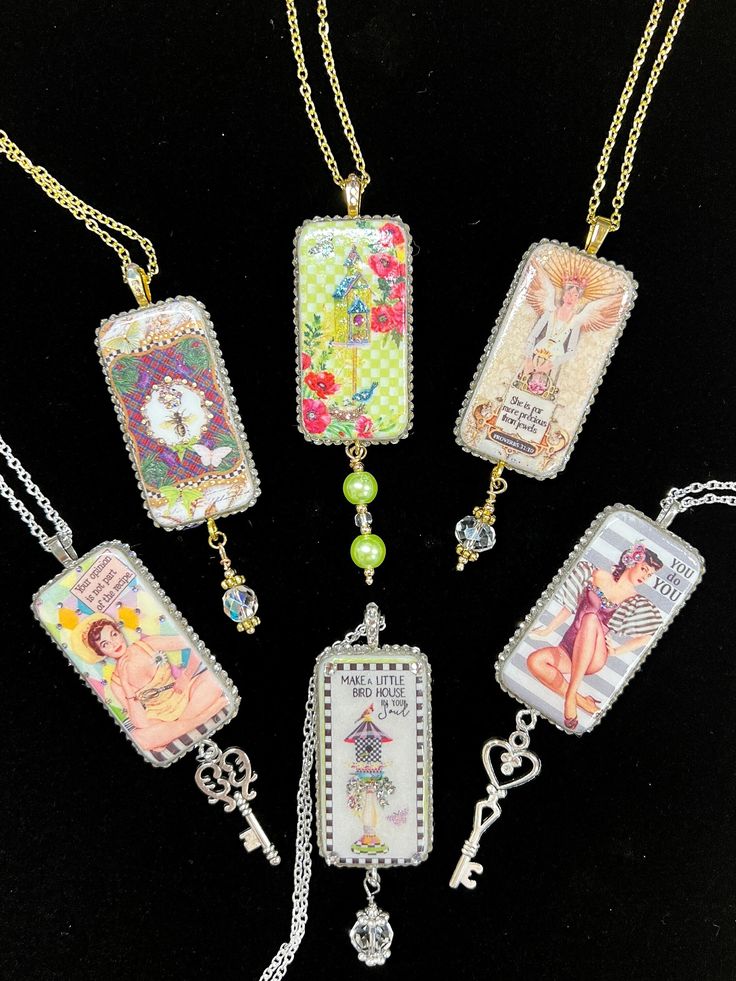 six necklaces with different designs on them