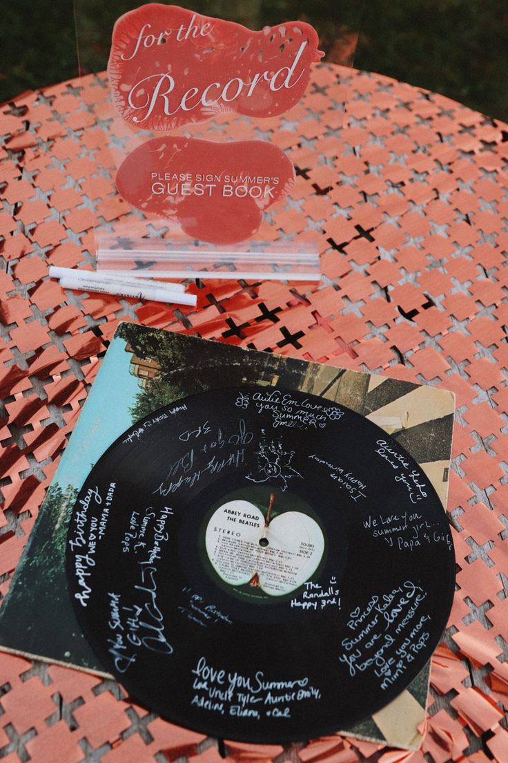 a record sitting on top of a table next to a sign that says for the record