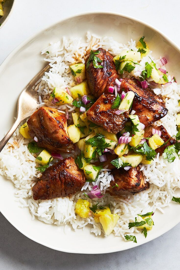 a white plate topped with rice and chicken