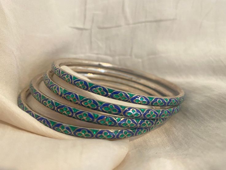 "-Sterling Silver Meenakari Bangles- Brightly colored, green and blue Mennakari bangle. Made from sterling silver, the bangle is then embellished with bright green and royal blue enamel in a traditional motif. Signed \"925\" on the inside. Excellent Condition *Please note, price is for one bangle (4 available)* Free Priority Mail Shipping" Luxury Meenakari Bangle For Festivals, Luxury Meenakari Bangle For Diwali, Traditional Blue Bangle For Gift, Traditional Handmade Green Bangle, Traditional Silver Enamel Bangle, Traditional Green Handmade Bangle, Green Bracelets For Ceremonial Festivals, Green Bracelets For Ceremonial And Festival Occasions, Green Meenakari Bracelets For Festivals