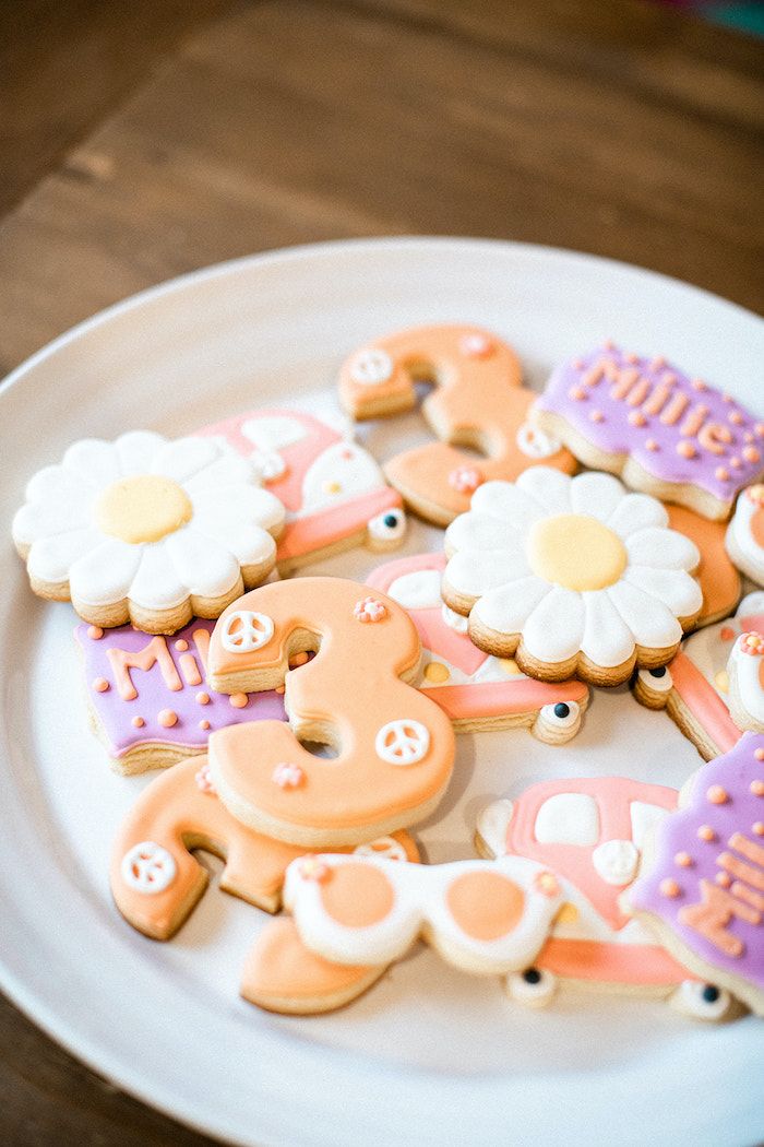 some decorated cookies are on a white plate