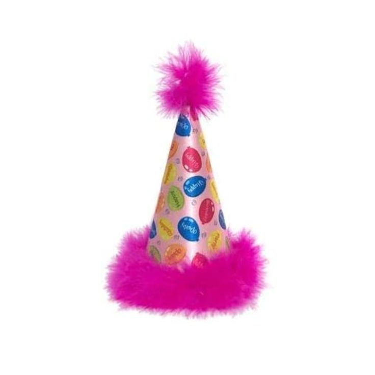 a party hat with pink fur trim and candy buttons on it, sitting on a white surface