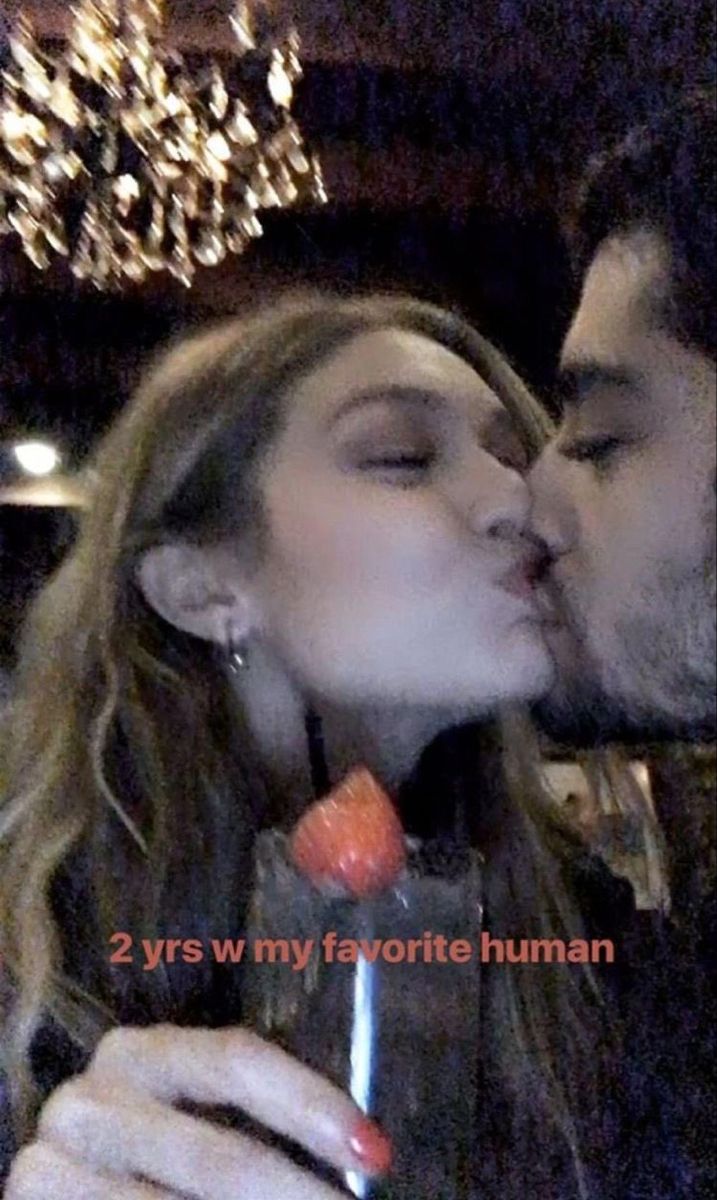 a man kissing a woman while holding a wine glass in front of her and the caption reads, 2 yrs w my favorite human