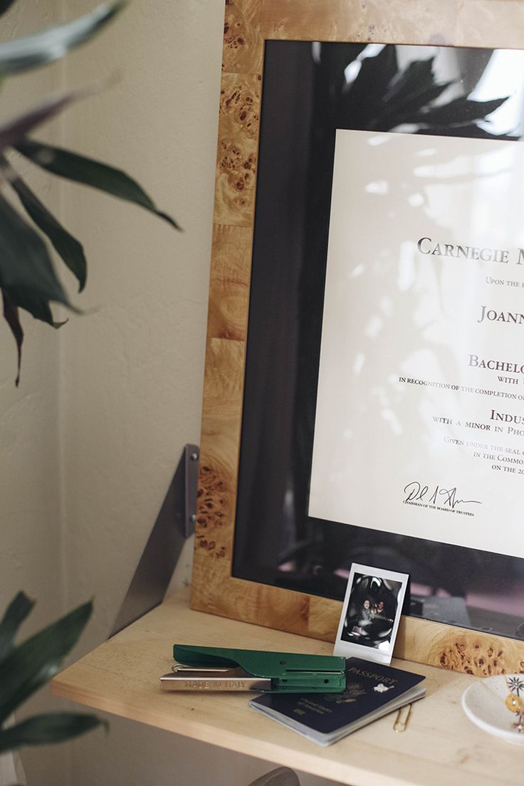 a wedding program is displayed on a table next to a framed photograph and other personal items