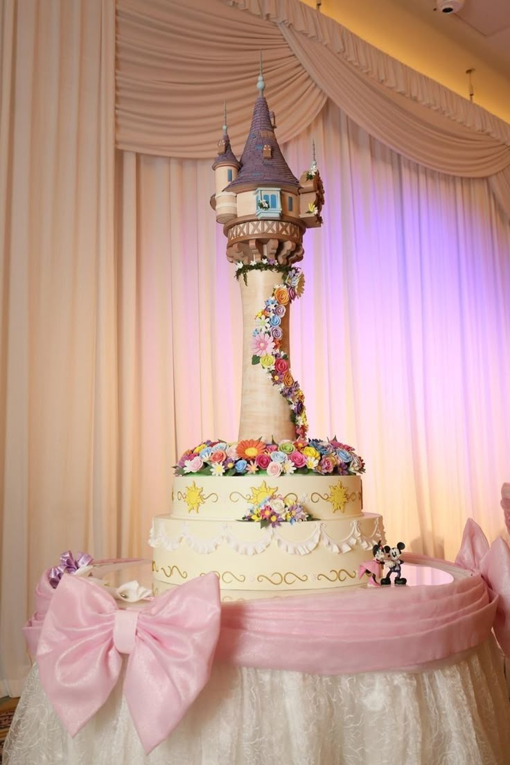 a wedding cake decorated with flowers and a castle on top