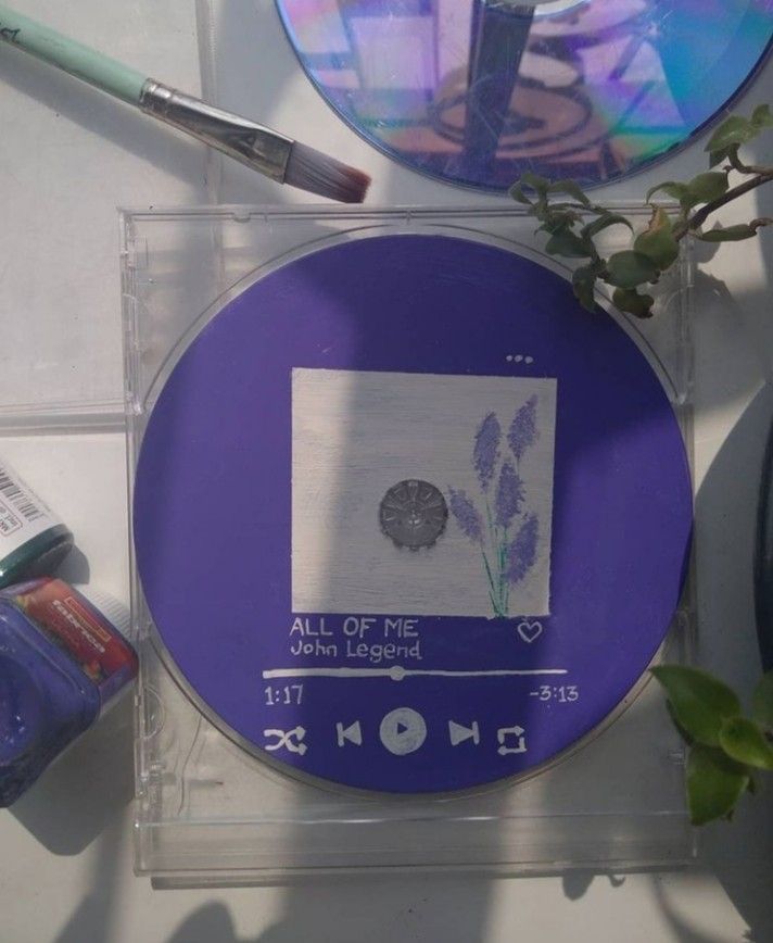 a purple cd with the words all of me written on it next to other items