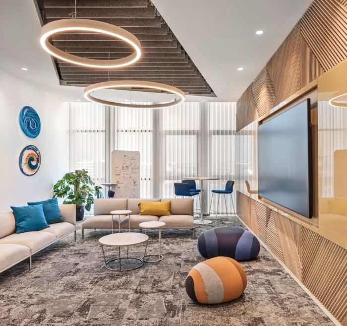 a living room filled with furniture and a flat screen tv mounted to the wall above it