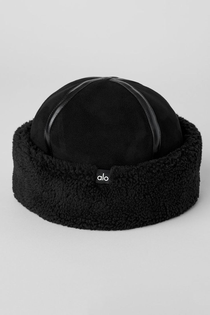 Achieve it-girl status in the Zhivago hat. It has a plush sherpa brim and a heat-retaining sherpa lining, plus a soft, suede-like crown with faux leather detailing. It’s the chicest way to battle winter chill—especially when you style it with a sherpa jacket. Adjustable High Crown Hats For Winter, Alo White Hat, Alo Baseball Cap, Black Hats With Plush Lining For Cold Weather, Alo Yoga Hat, Cozy Alo Yoga Hoodie With Ribbed Cuffs, Black Brimmed Hat With Fleece Lining, Winter Black Sheepskin Hats, Sauna Hat