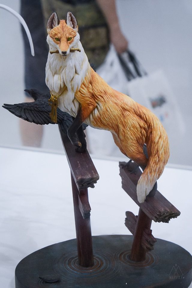 a figurine of a fox on a bench