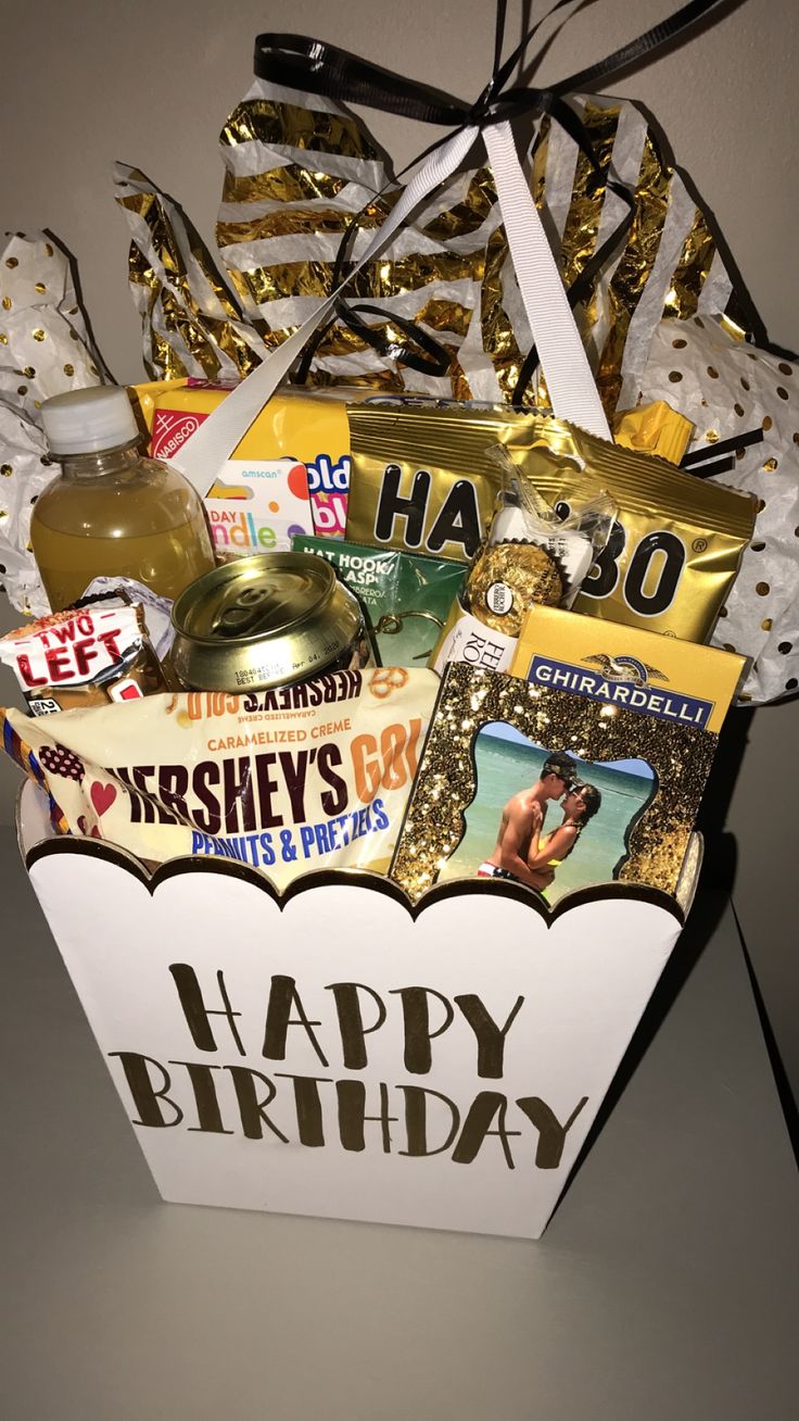 a happy birthday gift basket with confetti, candy, and other items in it