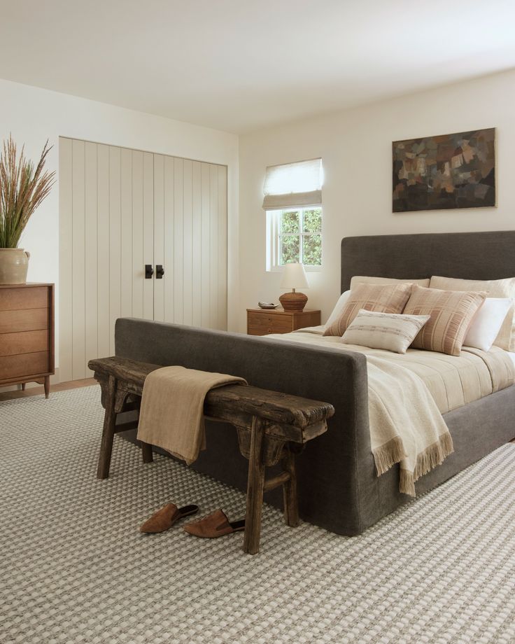 a bedroom with a large bed and wooden furniture in it's centerpieces