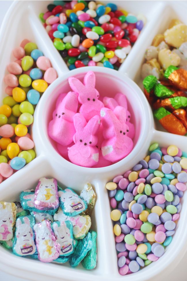 a tray filled with candy and candies in the shape of bunnies on top of each other