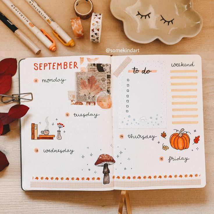 an open planner book sitting on top of a wooden table