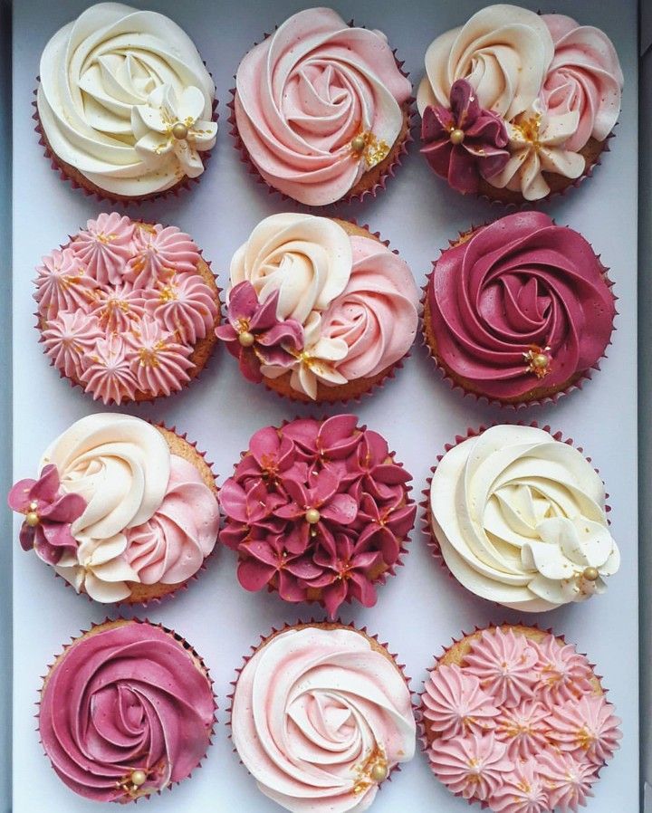 cupcakes with pink and white frosting in a box