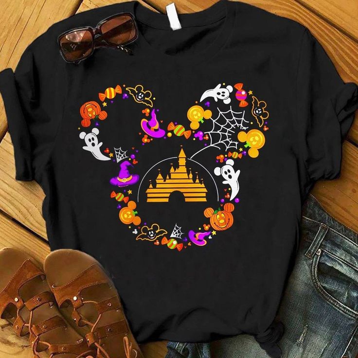 a mickey mouse halloween shirt with pumpkins and skulls on it, next to sunglasses