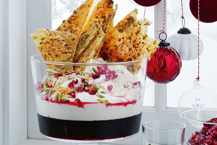 a bowl filled with food sitting on top of a window sill next to christmas decorations