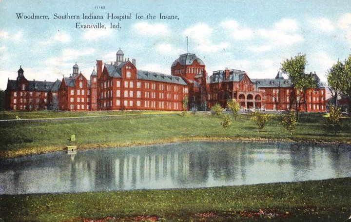 an old postcard shows a large building with a pond in the foreground and trees around it