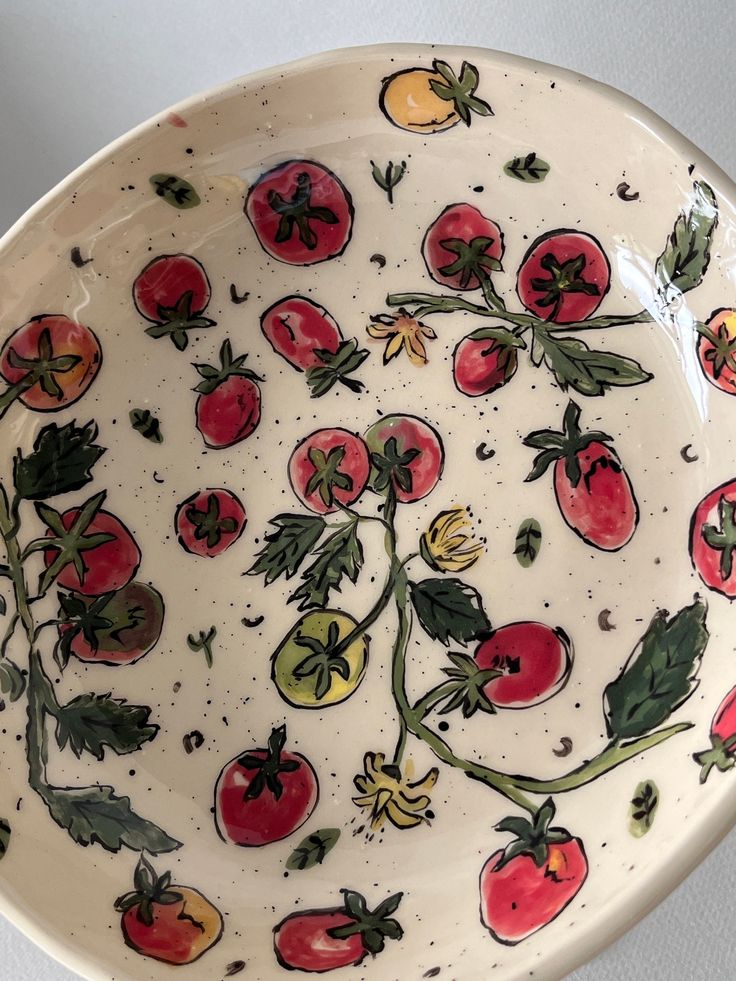 a bowl with tomatoes painted on it