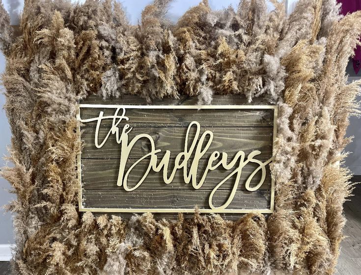 a wooden sign that says the crudleys on top of some fake fur